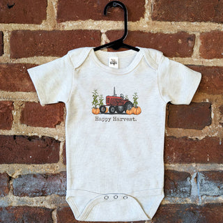 Baby onesie with tractor in the field