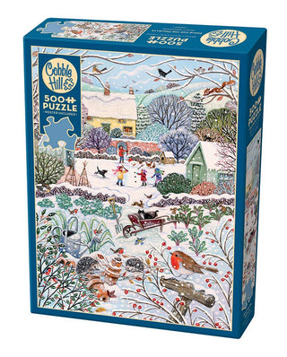 Winter Holidays 500-piece jigsaw puzzle featuring snowy holiday scene with children decorating a snowman, artwork by Lucy Grossmann | JSQ Mercantile – Women’s Boutique & Gift Shop in La Grange, IL
