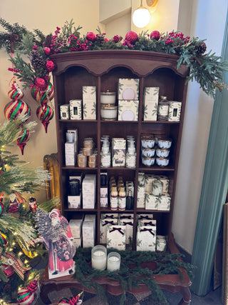 Frasier Fir candle collection with pine needle packaging styled with winter greenery, JSQ Mercantile – a women’s boutique and gift shop in La Grange, IL