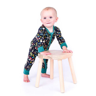 Baby standing up in night forest pajamas