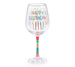 Stemmed Happy Birthday wine glass with multicolor lettering, candles, confetti, stars, and gift box with red bow, JSQ Mercantile – a women’s boutique and gift shop in La Grange, IL.