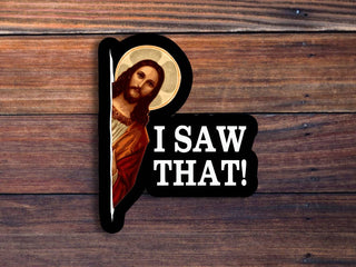 Sticker with a religious icon and 'I saw that!' text on a wooden background