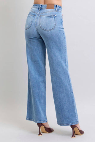 Blue jeans worn by a person on a light gray background
