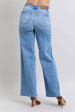 Light blue jeans worn by a person on a plain background