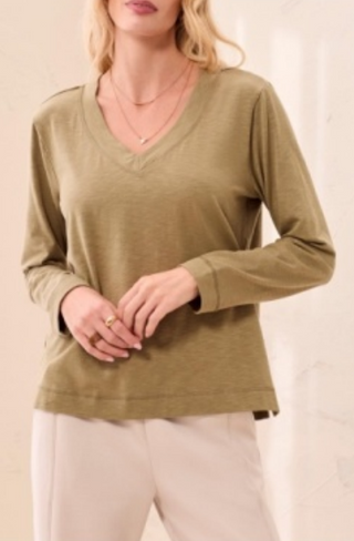 Long sleeve top in Aloe Green with a V neckline, worn by a female model.