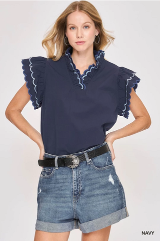 Navy cotton scallop trim ruffle sleeve top with relaxed fit and feminine detailing, styled for everyday wear – JSQ Mercantile – a women’s boutique and gift shop in La Grange, IL.