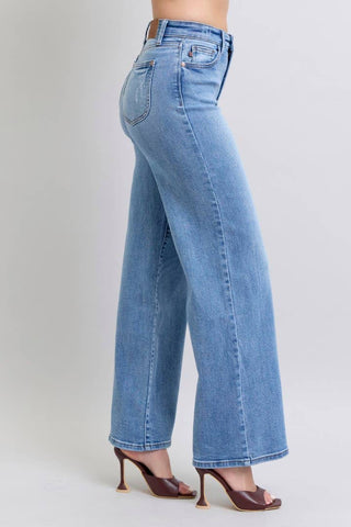 Light blue jeans worn by a person on a plain background