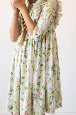 Girl wearing No Bunny Like You 3/4 sleeve ruffle twirl dress from JSQ Mercantile – a women’s boutique and gift shop in La Grange, IL.