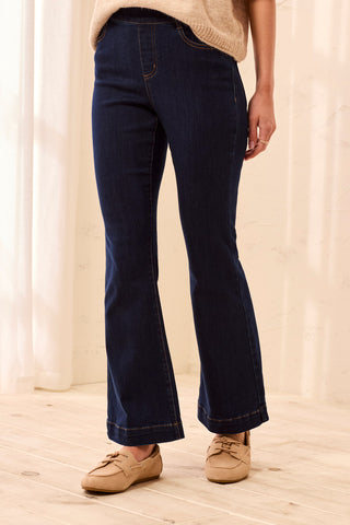 Darknight blue pull-on flare jeans with a tapered leg fit and smooth waistband, shown on a model.