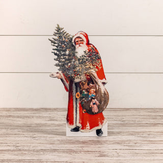 Vintage-inspired wooden Santa dummy board holding a Christmas tree, 18 inches tall, displayed on a holiday mantel at JSQ Mercantile – Women’s & Gift Boutique in La Grange, IL.